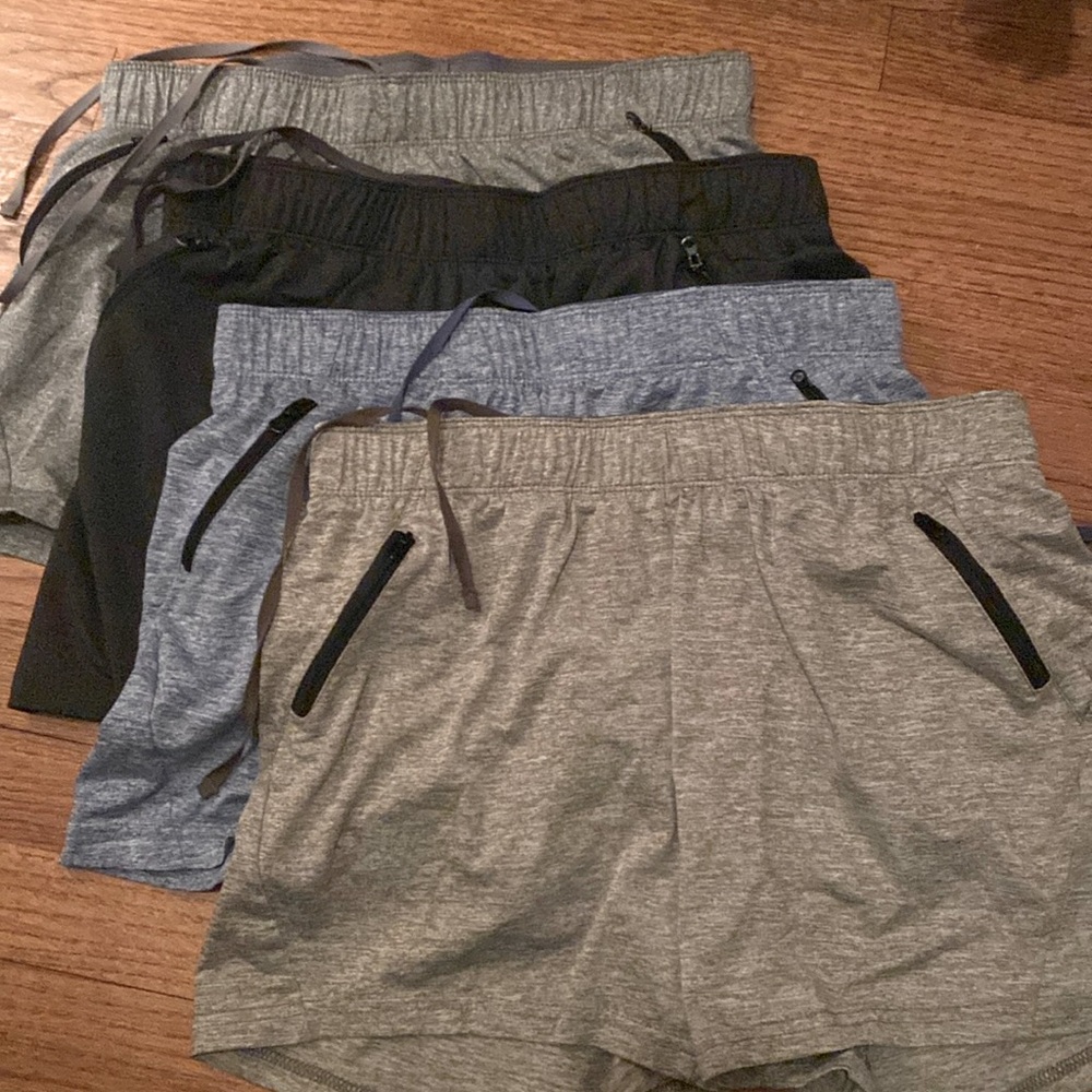 Four pairs of cool toned running shorts with zipper pockets.
